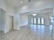 Bright living room with wood floors, chandelier, and French doors leading to the outdoors at 304 Denna Ln, Auburndale, FL 33823
