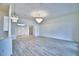 Open living room with hardwood floors, a modern chandelier, and lots of natural light at 304 Denna Ln, Auburndale, FL 33823