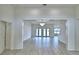 Spacious living room featuring wood floors, white walls, and modern chandelier lighting at 304 Denna Ln, Auburndale, FL 33823