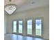 Living area with wood floors, a modern chandelier, and French doors at 304 Denna Ln, Auburndale, FL 33823