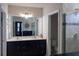 Elegant bathroom with double vanity, large mirror, and a walk-in shower at 3112 St Charles Pl, Winter Haven, FL 33884