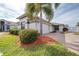 Exterior view of a house with a brick driveway and lush landscaping at 3445 Raleigh Dr, Winter Haven, FL 33884