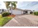 House exterior showcasing brick driveway and nicely landscaped front yard at 3445 Raleigh Dr, Winter Haven, FL 33884