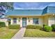 Inviting condo exterior featuring a teal roof and well-manicured landscaping at 345 24Th Nw St # 30, Winter Haven, FL 33880