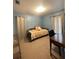 Bright bedroom with double bed, desk, and window coverings at 3746 Red Oak Ct, Lake Wales, FL 33898