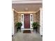 Charming front entrance with decorative door, sidelights, and inviting landscaping at 3746 Red Oak Ct, Lake Wales, FL 33898