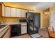 Functional kitchen with ample counter space, black appliances, and tile flooring at 3746 Red Oak Ct, Lake Wales, FL 33898