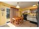 Bright kitchen with wood table and black appliances at 3746 Red Oak Ct, Lake Wales, FL 33898