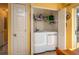 Convenient laundry room with a modern washer and dryer, plus shelving for storage at 3746 Red Oak Ct, Lake Wales, FL 33898