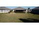 Spacious backyard with lush green grass, mature landscaping, and room for outdoor activities at 3926 Bedford Ave, Winter Haven, FL 33884