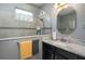 This bathroom features a glass shower, a dark vanity, and a light gray countertop at 3926 Bedford Ave, Winter Haven, FL 33884