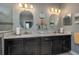 This bathroom features dual dark vanities with light countertops and matching oval mirrors at 3926 Bedford Ave, Winter Haven, FL 33884