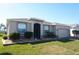 Charming single-story home with well-manicured lawn and attached two-car garage and upgraded stone exterior at 3926 Bedford Ave, Winter Haven, FL 33884