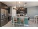 This kitchen features stainless steel appliances, dark wood cabinets, and a center island with bar seating at 3926 Bedford Ave, Winter Haven, FL 33884