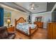 Bright main bedroom boasting a decorative bed frame, ceiling fan, and dual dressers at 3926 Bedford Ave, Winter Haven, FL 33884