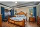Bright main bedroom boasting a decorative bed frame, ceiling fan, and private access to the lanai at 3926 Bedford Ave, Winter Haven, FL 33884