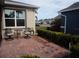 Cozy outdoor patio featuring brick pavers and comfortable seating, perfect for enjoying the beautiful neighborhood view at 3926 Bedford Ave, Winter Haven, FL 33884