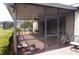 Inviting screened-in patio with brick pavers, string lights, and comfortable seating area for relaxation and enjoyment at 3926 Bedford Ave, Winter Haven, FL 33884