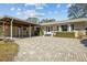 Inviting home exterior featuring a brick facade and a paved driveway at 412 Hillcrest Se Dr, Winter Haven, FL 33884