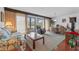 Living area with sliding glass doors leading to patio, featuring seating and a game table at 4131 Abbey Ct, Haines City, FL 33844