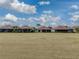 Back view of homes with lanais and grassy area at 4240 Dunmore Dr, Lake Wales, FL 33859