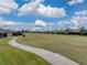 Golf course homes and walkway on sunny day at 4240 Dunmore Dr, Lake Wales, FL 33859
