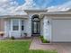 Home's entryway with a charming walkway and landscaping at 4240 Dunmore Dr, Lake Wales, FL 33859