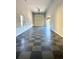 Spacious garage with large roll-up door and checkered floor at 4240 Dunmore Dr, Lake Wales, FL 33859