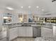 Open kitchen features granite island and breakfast bar at 4240 Dunmore Dr, Lake Wales, FL 33859