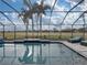 Screened pool with a view of the golf course at 4240 Dunmore Dr, Lake Wales, FL 33859