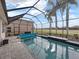 Screened pool with a view of the golf course at 4240 Dunmore Dr, Lake Wales, FL 33859