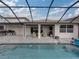 Covered patio with seating area adjacent to refreshing pool at 4240 Dunmore Dr, Lake Wales, FL 33859