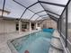 Enclosed pool area with patio furniture and outdoor kitchen at 4240 Dunmore Dr, Lake Wales, FL 33859