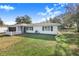 Ranch style home with a spacious lawn and dark garage door at 428 Durrell Ct, Winter Haven, FL 33884