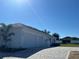 Side view of home featuring three-car garage and a paved driveway at 4593 Emerald Palms Dr, Winter Haven, FL 33884