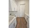 Bright laundry room with white cabinets and countertop at 4593 Emerald Palms Dr, Winter Haven, FL 33884