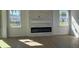 Bright living room with fireplace, large windows and hard wood flooring at 4593 Emerald Palms Dr, Winter Haven, FL 33884