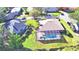 Aerial view showing home, pool, and lush landscaping at 514 Lake Mariam Ter, Winter Haven, FL 33884