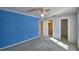 Bedroom with blue walls and ceiling fan at 514 Lake Mariam Ter, Winter Haven, FL 33884