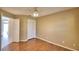 Spacious bedroom with double doors, wood flooring, and closet at 514 Lake Mariam Ter, Winter Haven, FL 33884