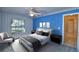 Bedroom with blue walls and ceiling fan at 514 Lake Mariam Ter, Winter Haven, FL 33884