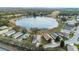 Wide aerial view of the community, highlighting lake and homes at 524 Lake Suzanne Dr, Lake Wales, FL 33859