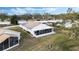 Aerial view showing home's backyard, screened patio, and spacious lawn at 524 Lake Suzanne Dr, Lake Wales, FL 33859