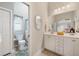 Bathroom with double vanity, white cabinets, and a shower/tub combo at 524 Lake Suzanne Dr, Lake Wales, FL 33859
