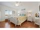 Charming bedroom with hardwood floors and floral bedding at 524 Lake Suzanne Dr, Lake Wales, FL 33859