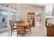 Bright dining area with a round table, four chairs, and access to a patio at 524 Lake Suzanne Dr, Lake Wales, FL 33859