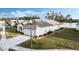 Exterior view of home with a two-car garage and a nicely landscaped yard at 524 Lake Suzanne Dr, Lake Wales, FL 33859