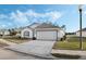 House exterior showcasing a two-car garage and landscaped yard at 524 Lake Suzanne Dr, Lake Wales, FL 33859