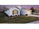 White house with green shutters, landscaping, and a two-car garage at 524 Lake Suzanne Dr, Lake Wales, FL 33859