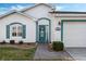 Welcoming front entry with teal door, and brick walkway at 524 Lake Suzanne Dr, Lake Wales, FL 33859